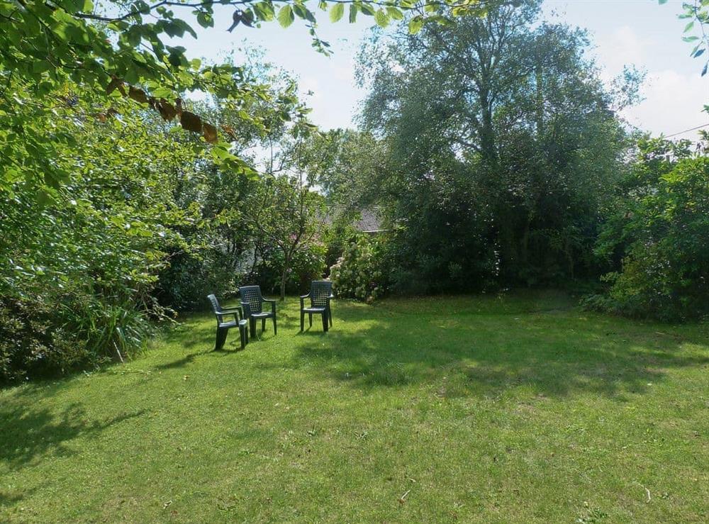 Peaceful garden with furniture for sitting out at Lynches in Parkham, near Bideford, Devon
