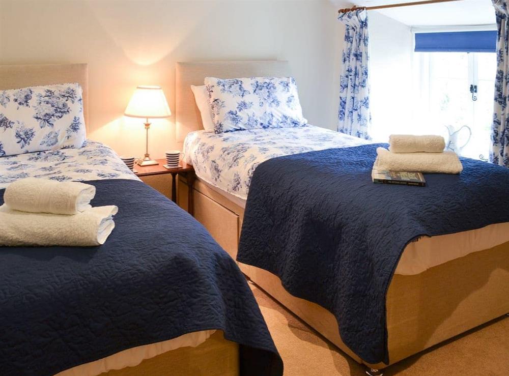Twin bedded room with sloping ceiling at Lynches in Parkham, near Bideford, Devon