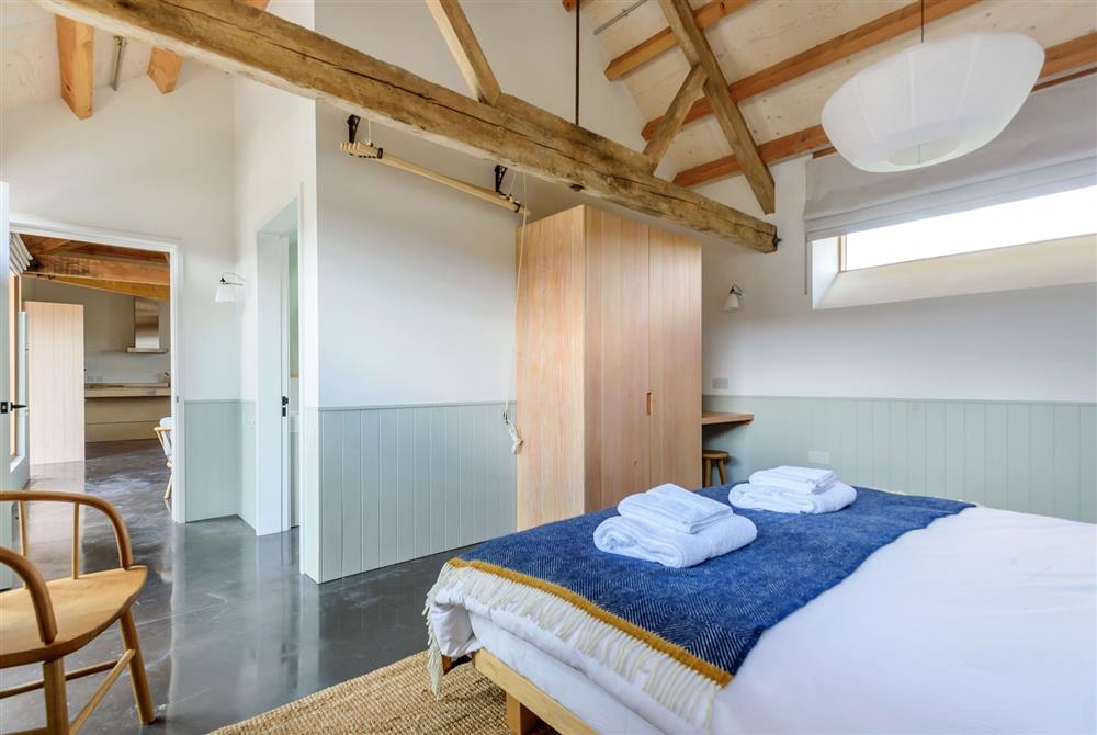 Bedroom one with a 6’ super-king size bed and en-suite bathroom at Lynchets, Dorchester