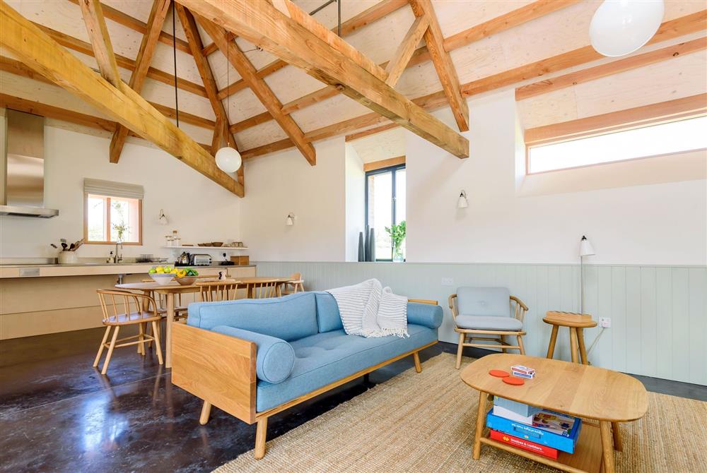The open-plan day space with exposed beams and stylish furnishings