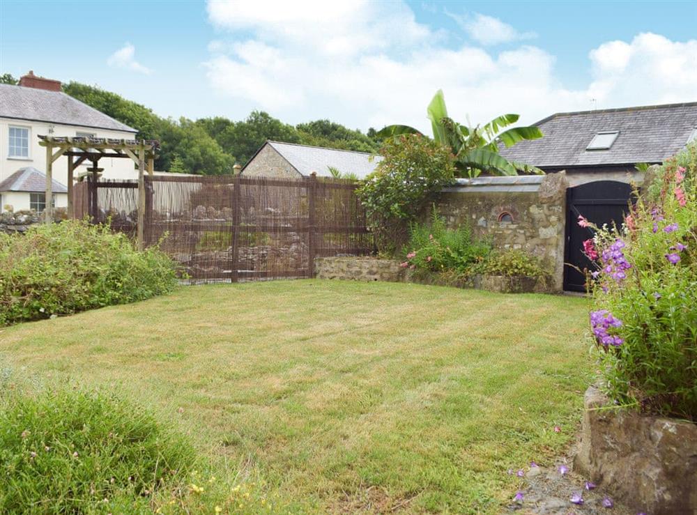 Lawned garden with attractive planting at The Byre, 