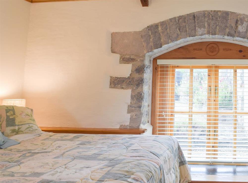 Lovely bedroom with feature exposed stonework at The Byre, 