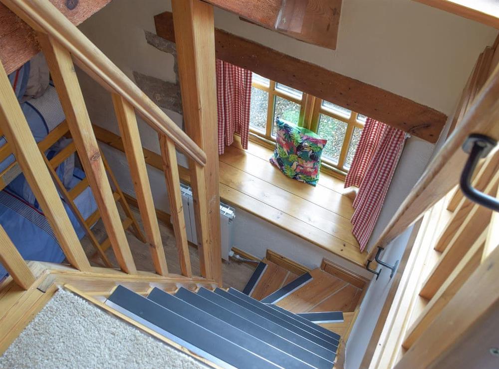 Steep staircase leading to a mezzanine sitting area