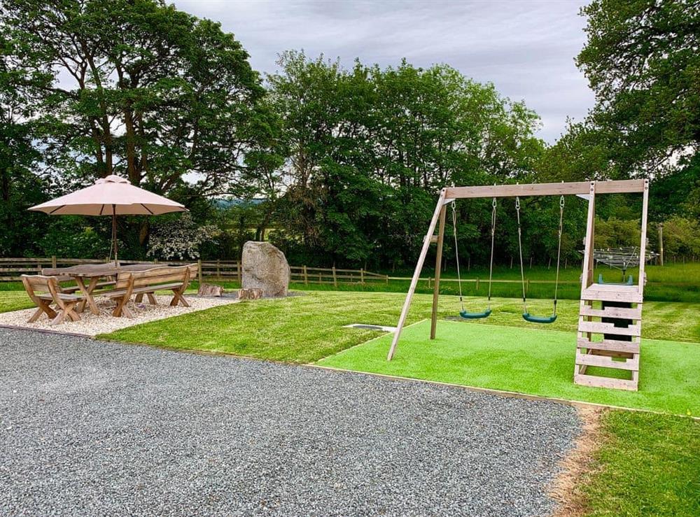 Children’s play area in the garden at Maen Llwyd in Llanyre, near Llandrindod Wells, Powys