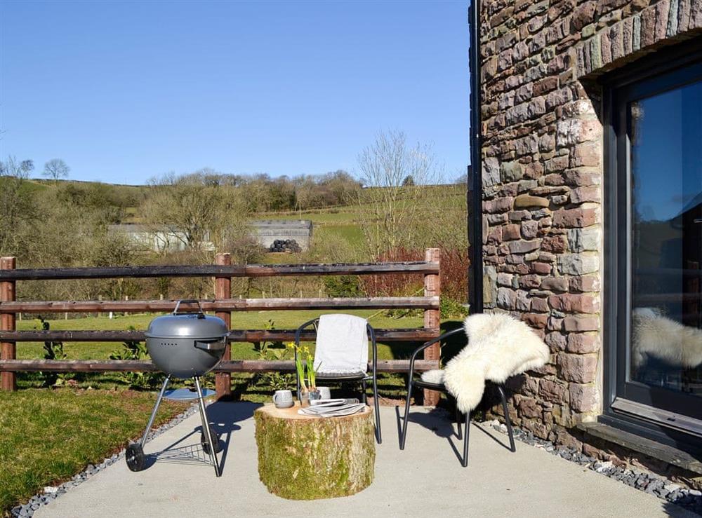 Patio with garden furniture and BBQ at Maes Merlin in Llanddeusant, near Llangadog, Carmarthenshire, Dyfed