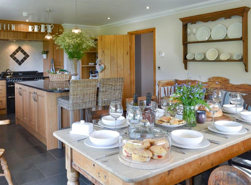 Convenient dining area within kitchen at Maes Y Bryn Farmhouse in Llansadwrn, near Llandeilo, Dyfed