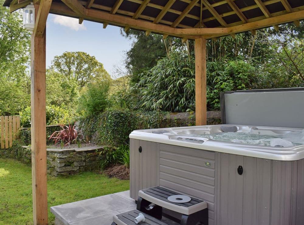 Relax in the secluded and private hot tub at Maes Yr Onnen in Abercych, near Cardigan, Dyfed