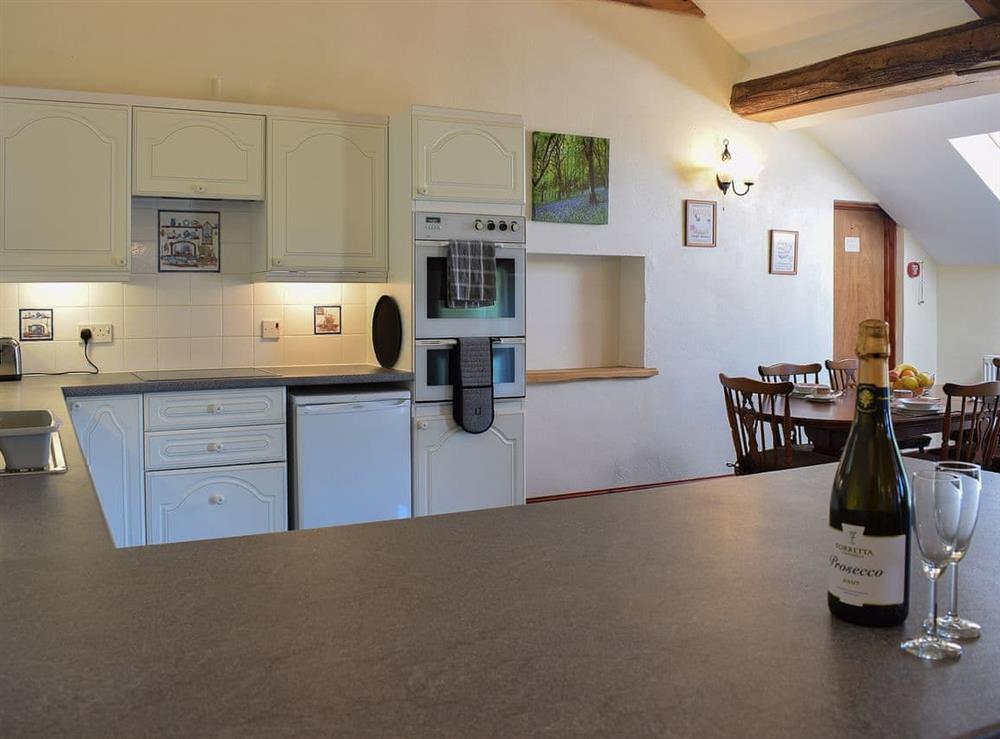 Spacious kitchen with breakfast bar at Dan Y Coed, 