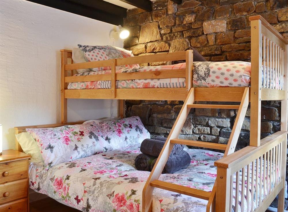 Bunk beds with a double and child’s single bunk overhead