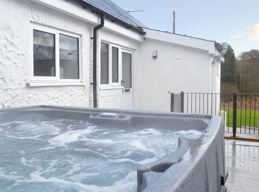 Relax and enjoy the private hot tub at Kingfisher, 
