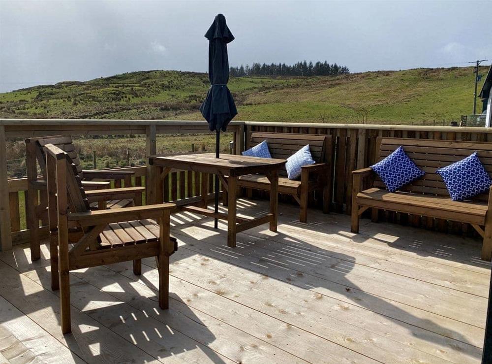 Large decked area to the front overlooking the surrounding fields and hills at Maggies Cabin in Oban, Argyll