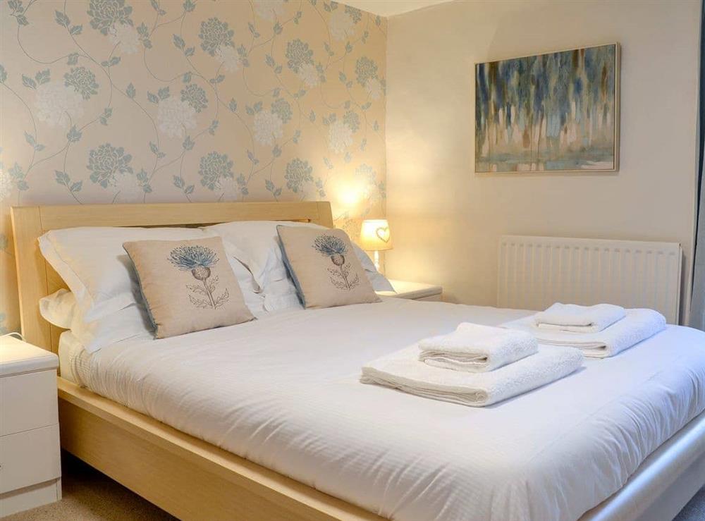 Relaxing bedroom with kingsize bed at Maggies Den in Gatehouse of Fleet, Dumfries and Galloway, Kirkcudbrightshire
