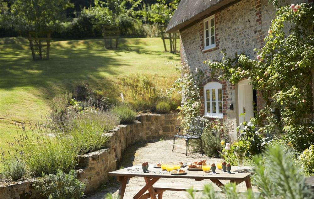 Delightful garden with outdoor seating at Magna Cottage, Ashmore