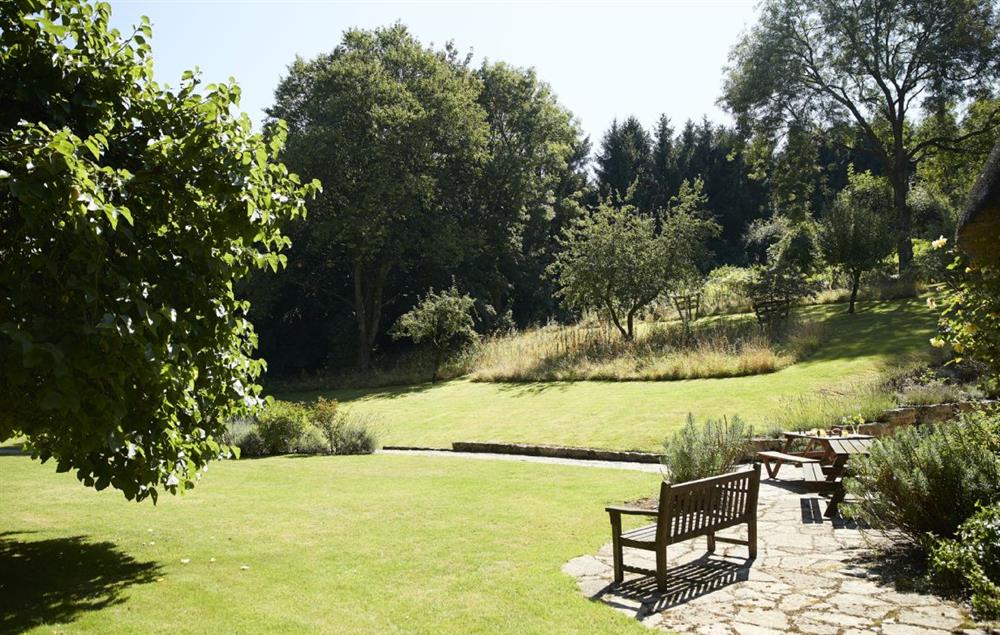Stunning gardens all around the cottage with seating at Magna Cottage, Ashmore