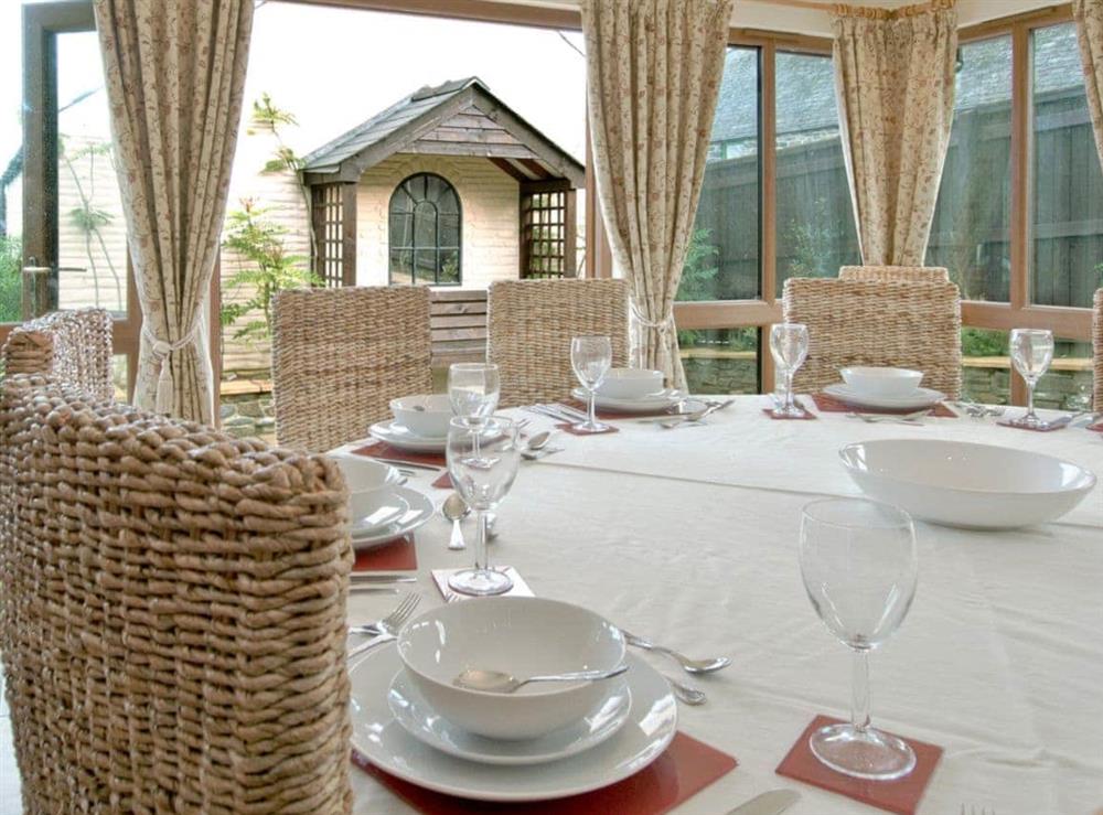 Dining area with french doors opening onto the garden at Magnolia Cottage in Aberaeron, Dyfed