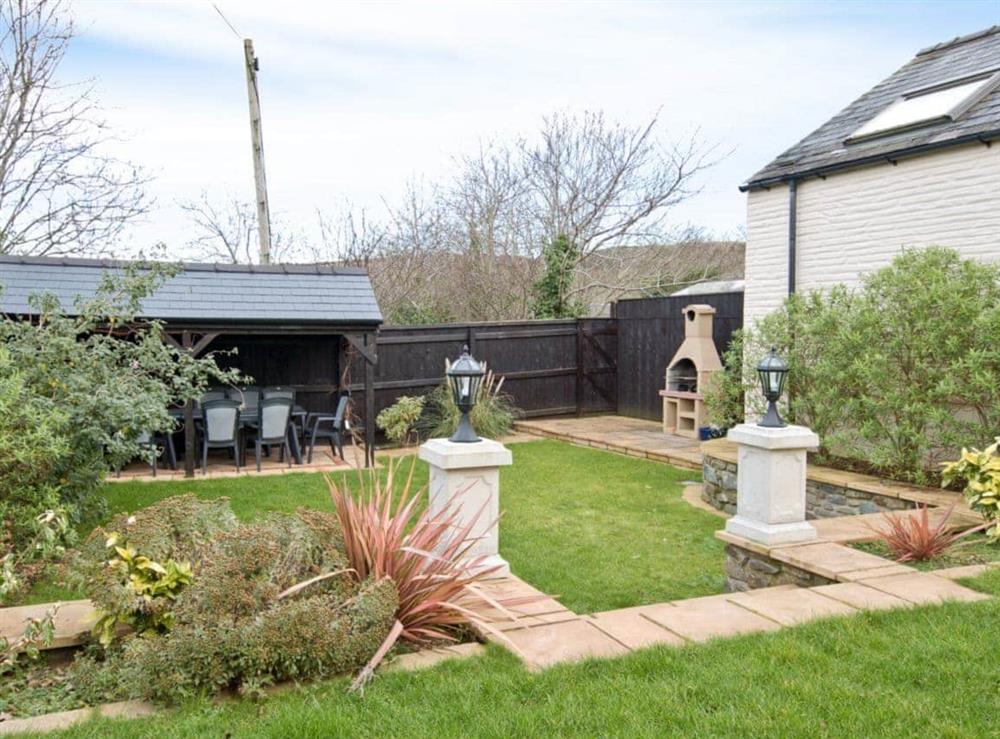 Large garden with BBQ and dining facilities at Magnolia Cottage in Aberaeron, Dyfed