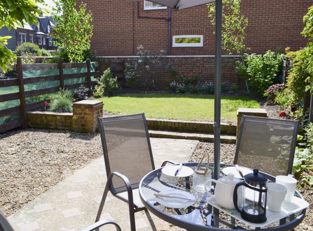 Enclosed lawned garden with sitting-out area and garden furniture (photo 2) at Magnolia Lodge in Sheringham, Norfolk, England