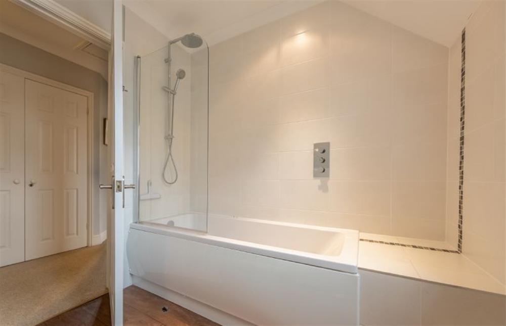 First floor: The bathroom has bath with shower over at Mahonia Cottage, Burnham Market near Kings Lynn