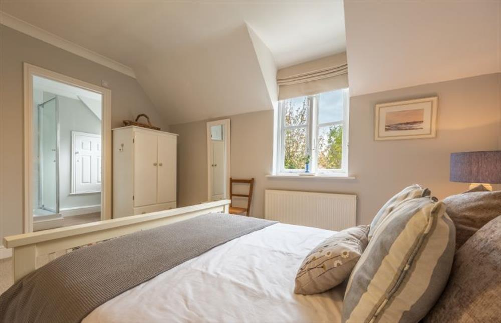 First floor: The master bedroom has king-size bed at Mahonia Cottage, Burnham Market near Kings Lynn