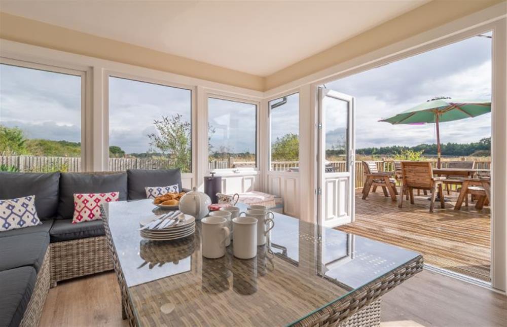 Ground floor: Sunroom with french doors to the decked terrace