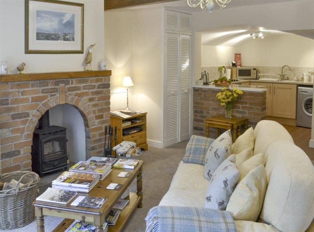 Living room with open aspect to kitchen at Mallard Cottage in Holmfirth, West Yorkshire