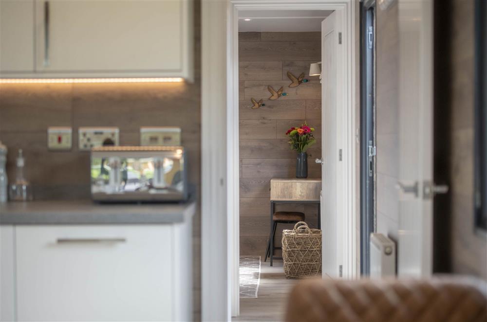 The open-plan living area leading into the bedroom at Mallard House Lodge, Nr. Penrith