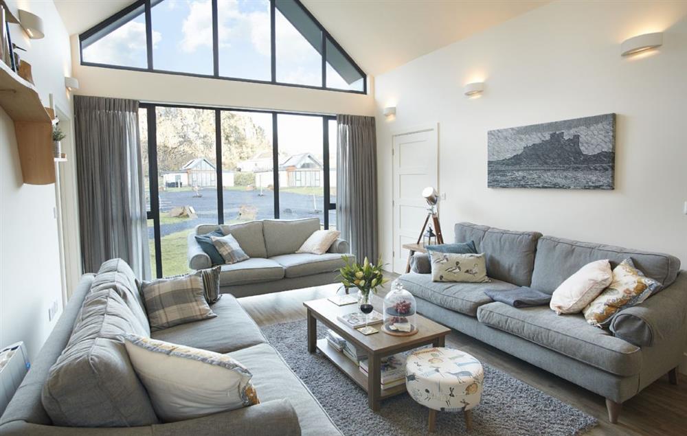 The stunning sitting room with comfortable sofas (the third sofa has been replaced with two armchairs since the image was taken)