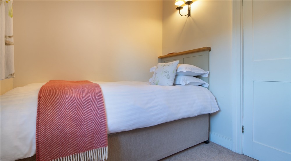 One of the beds in the twin bedroom at Malt House in Saltash, Cornwall