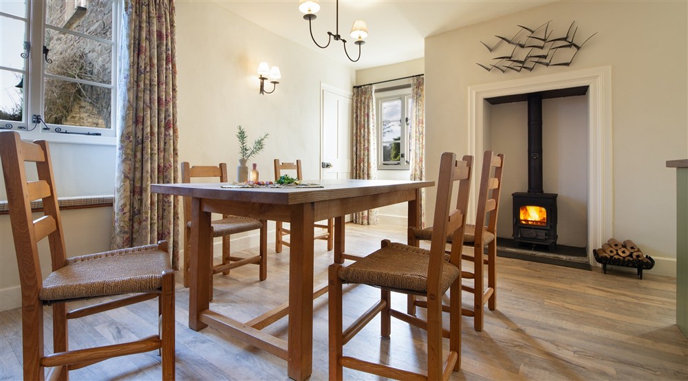 The dining area with multi-fuel stove at Malt House in Saltash, Cornwall