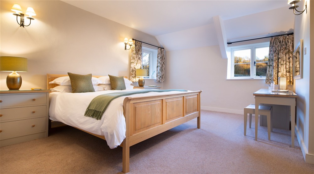 The main bedroom with double bed and en-suite shower room at Malt House in Saltash, Cornwall