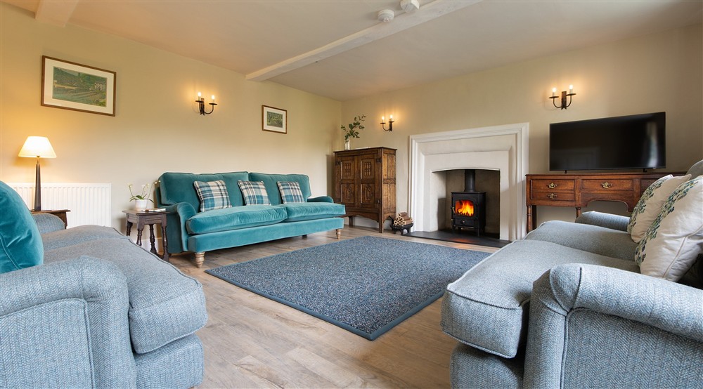 The sitting room with woodburner, sofas and television (photo 2) at Malt House in Saltash, Cornwall
