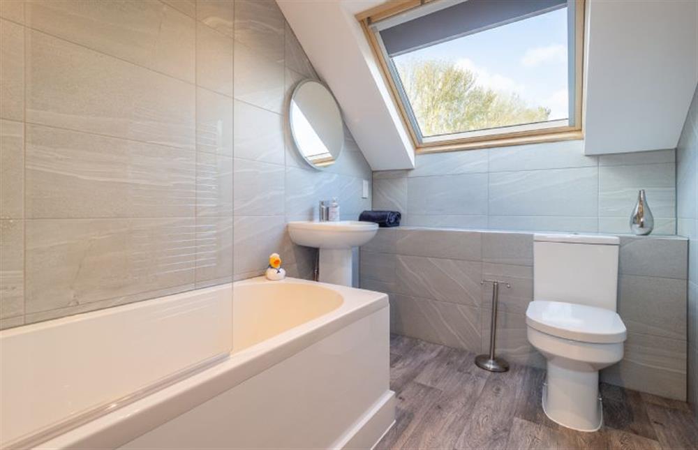 Family bathroom with bath with shower over, wash basin and WC at Maltings Lodge, Chelsworth