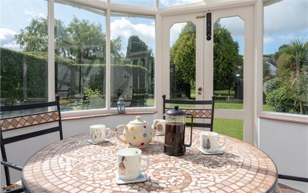 Enjoy some afternoon tea in the conservatory. at Manor Cottage in Dittisham