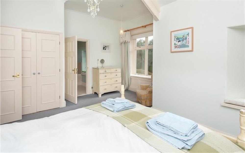 The master bedroom leading through to the ensuite bathroom. at Manor Cottage in Dittisham