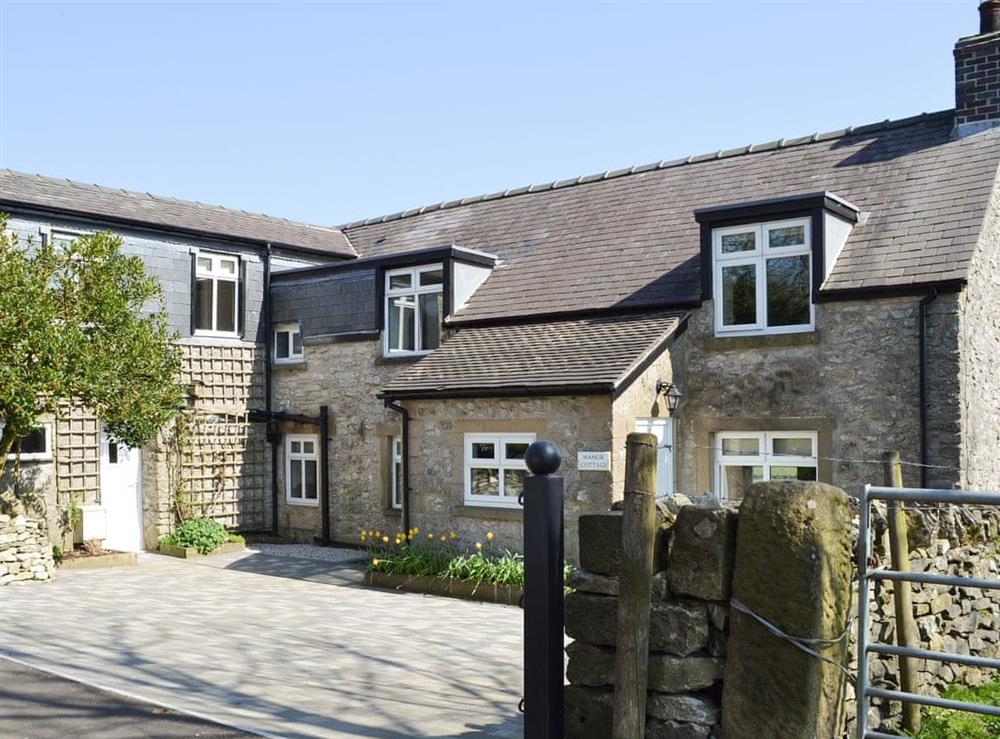 Exterior with parking at Manor Cottage in Wardlow, near Buxton, Derbyshire, England