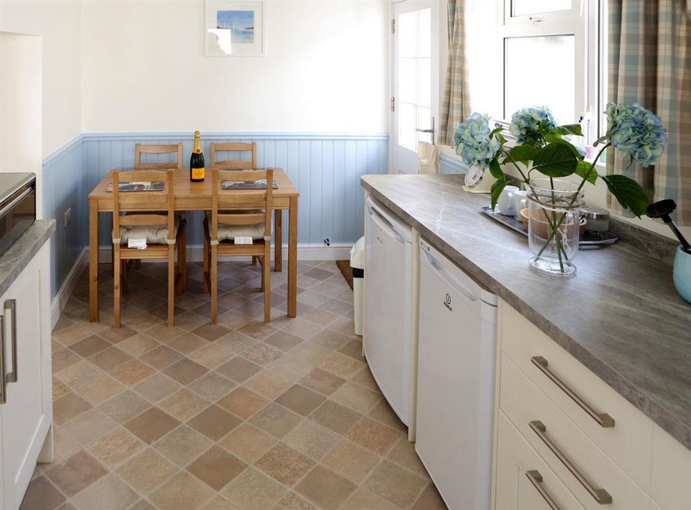 Convenient dining area within kitchen at Manor Cottage in West Pentire, Cornwall., Great Britain