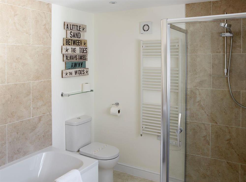 Family bathroom with separate walk-in shower cubicle at Manor Cottage in West Pentire, Cornwall., Great Britain