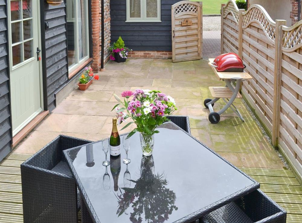 Enclosed courtyard with outdoor furniture and BBQ at Owls Roost, 