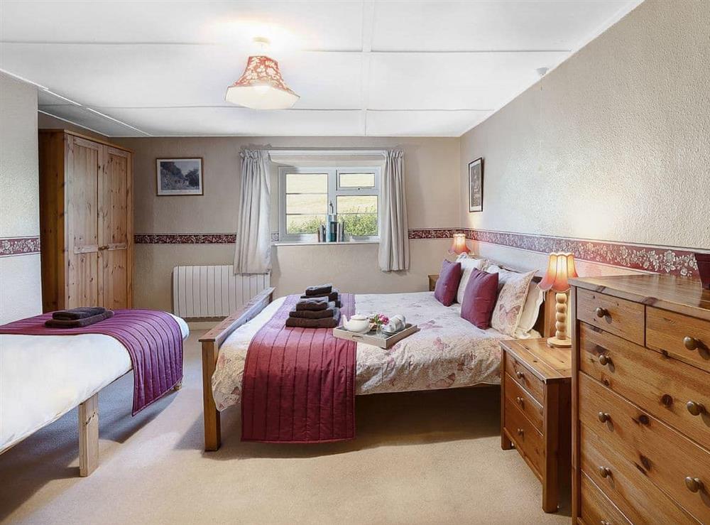 Master bedroom with double and single beds at Manor Farm in Daccombe, near Torquay, Devon