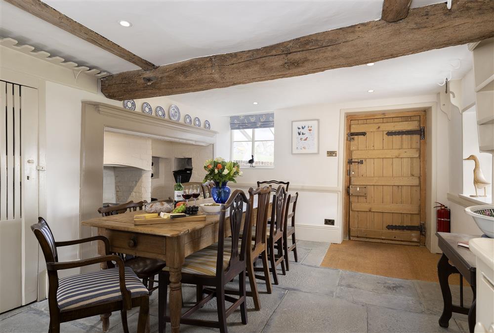Dining room with seating for ten guests and wood burning stove at Manor Farm, Grafton, Nr Beckford
