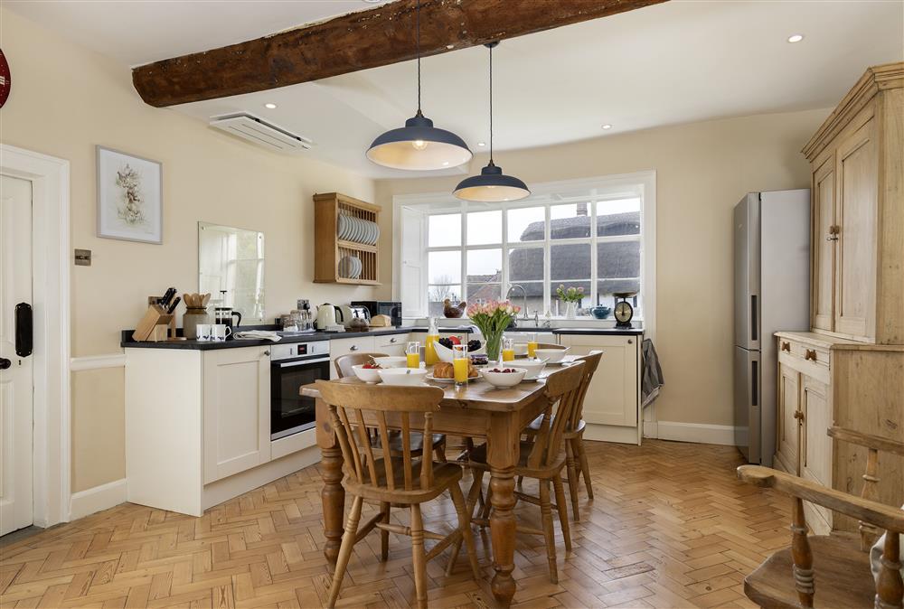 Kitchen with breakfast table and chairs at Manor Farm, Grafton, Nr Beckford