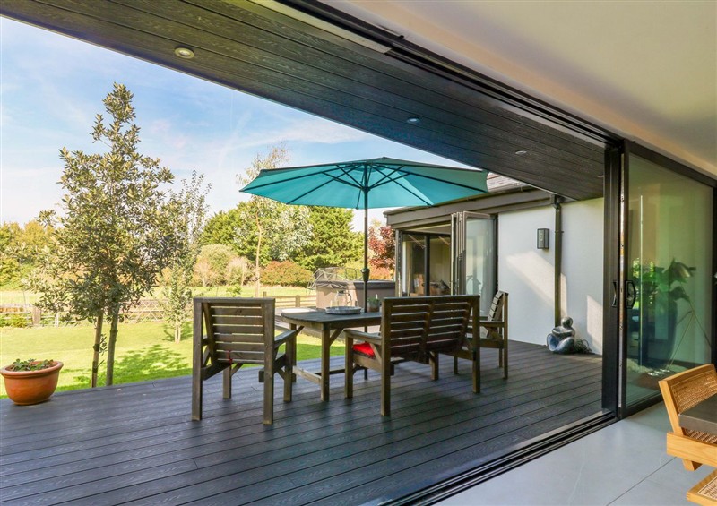 Enjoy a glass of wine on the patio at Manor Farm House, Merton near Bicester