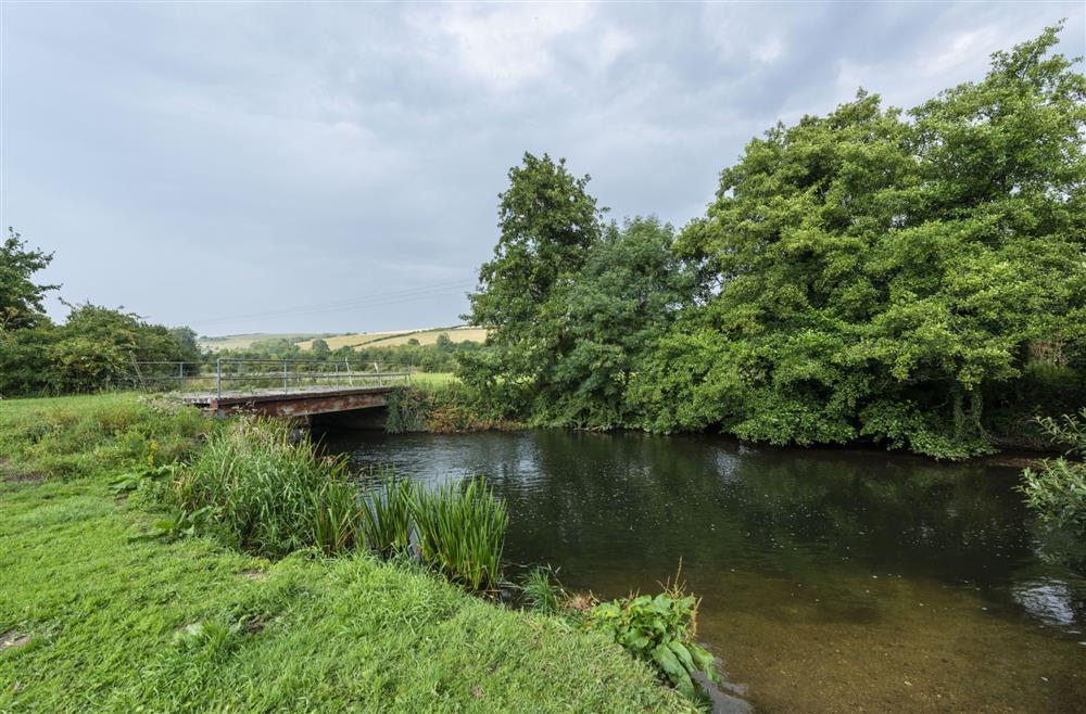 The River Frome runs along the bottom of the extensive garden at Manor Farmhouse, Dorchester