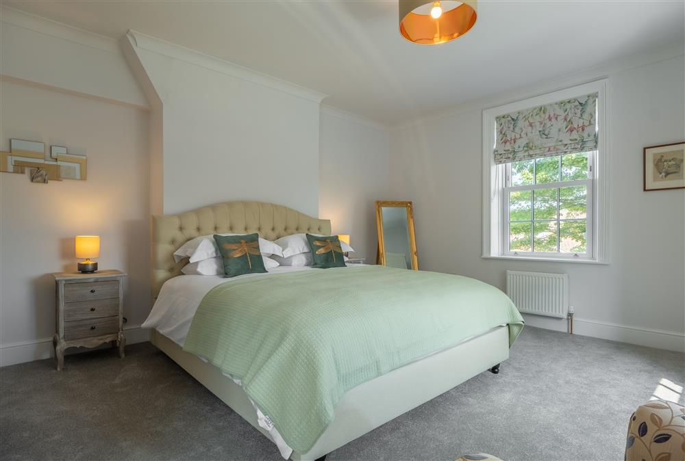 First floor: Bedroom two with a super-king size bed at Manor House, Beeford