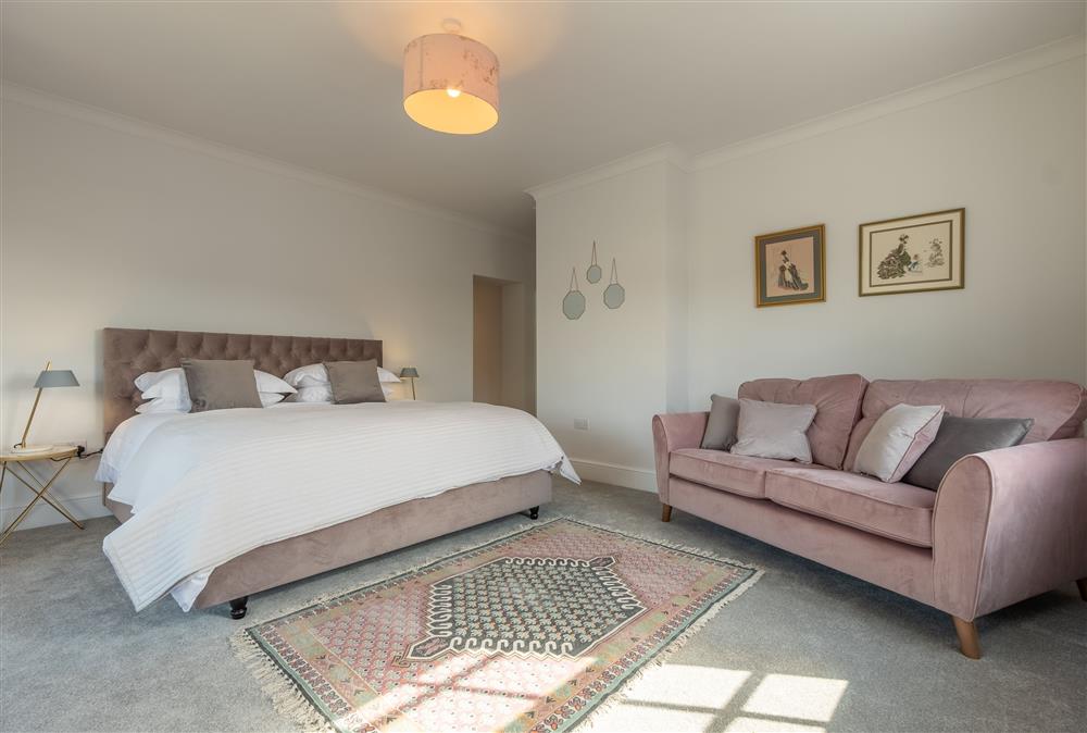 First floor: Master bedroom with 6ft super-king bed and stylish sofa at Manor House, Beeford