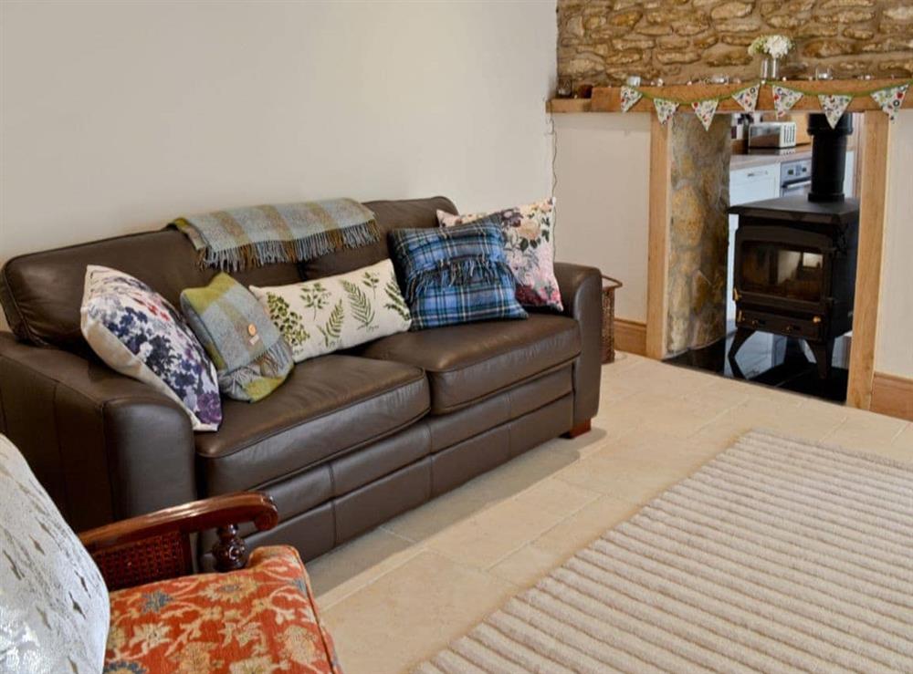 Living room with wood burner at Manor House Dairy Cottage in East Ayton, near Scarborough, North Yorkshire