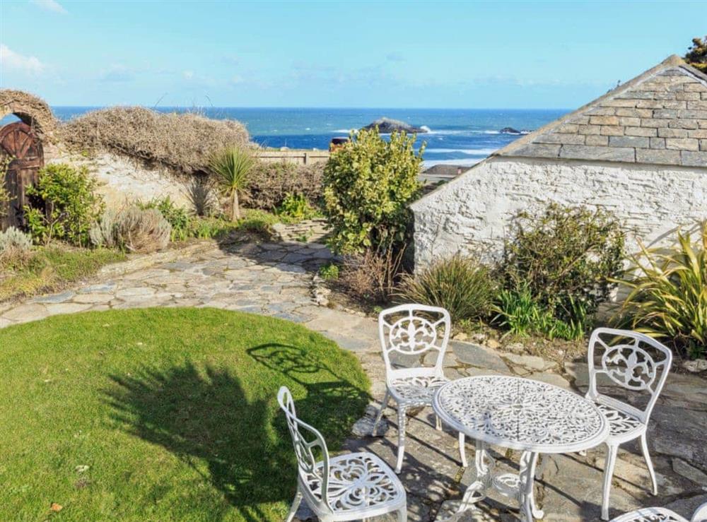 Garden seating area with stunning sea views at Manor House in West Pentire, Cornwall., Great Britain
