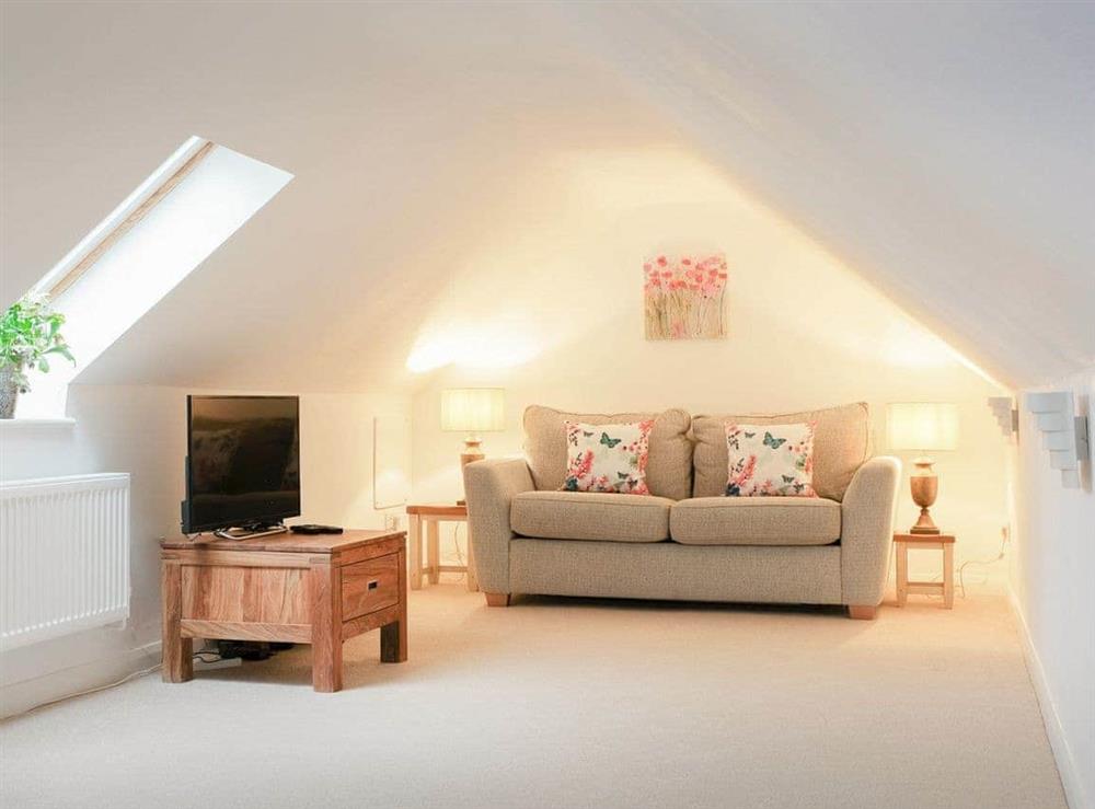 Additional cozy seating area with Freeview TV and sofa bed at Maple Lodge in Corsham, Wiltshire
