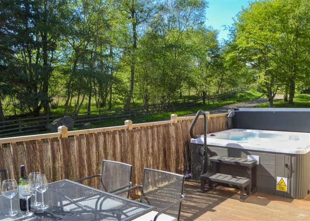 Peacful decking with seating area and private hot tub at Maple Lodge in Otterburn, near Bellingham, Northumberland