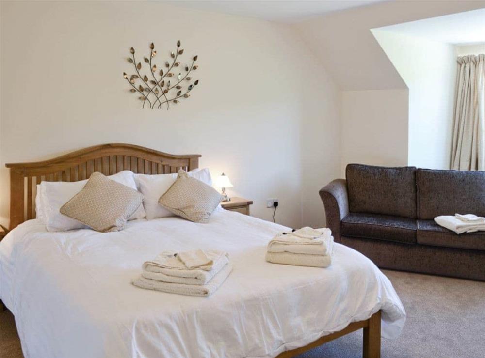 Double bedroom with 5ft bed, river views and en-suite shower room at March Cottage in Glen Cassley, near Lairg, Sutherland